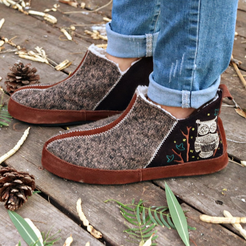 Women's Forest Bootie Slippers in Chocolate On Model with Leaves and Pine Cones#color_chocolate