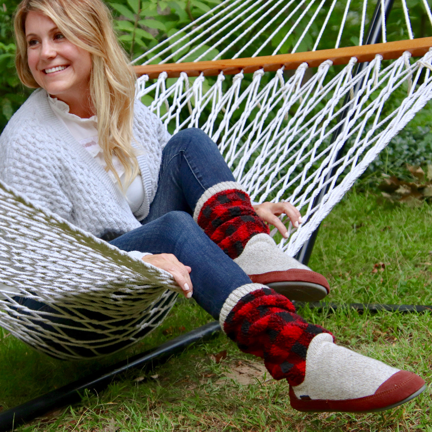 Women's Slouch Boots in Classic Buffalo Plaid On Model Sitting in a Hammock#color_classic-buffalo-plaid