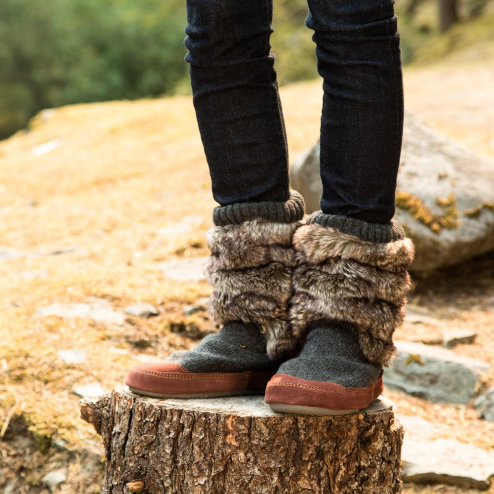 Women's Slouch Boots in Charcoal Faux Fur On Model Standing on Tree Stump#color_charcoal-faux-fur