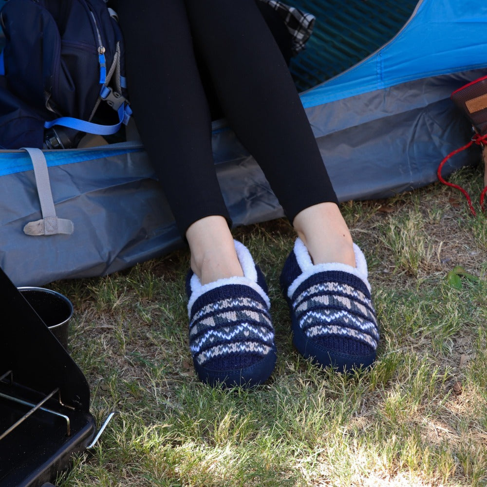 Women's Nordic Moccasins on figure sitting outside of tent#color_nordic-blue