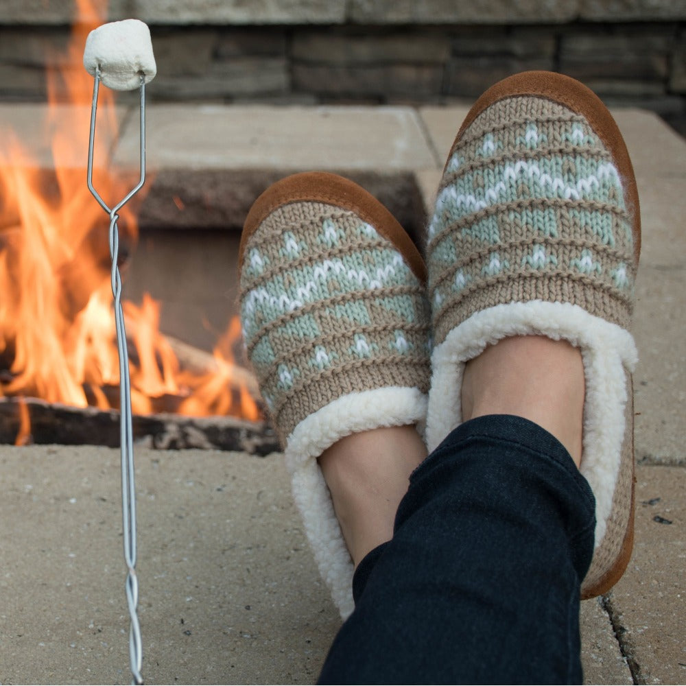Women's Nordic Moccasins on figure sitting by fire with feet up roasting marshmellows#color_nordic-oatmeal-heather