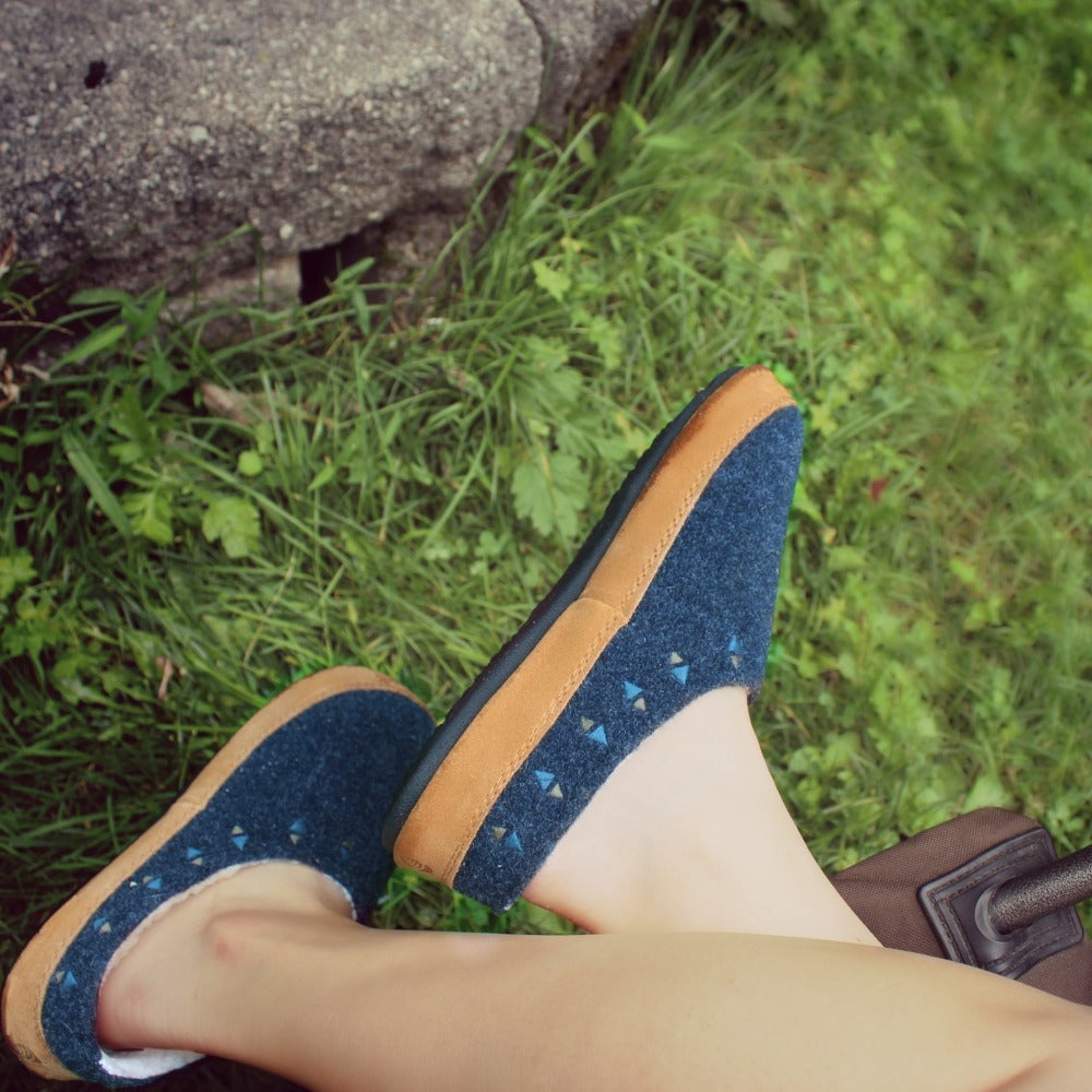 Women's Geo Embroidered Hoodback Slippers on figure sitting outside on chair#color_navy