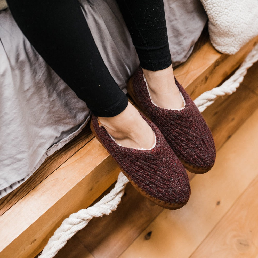 Women's Recycled Camden Moccasins in garnet on figure sitting on the side of a bed#color_garnet