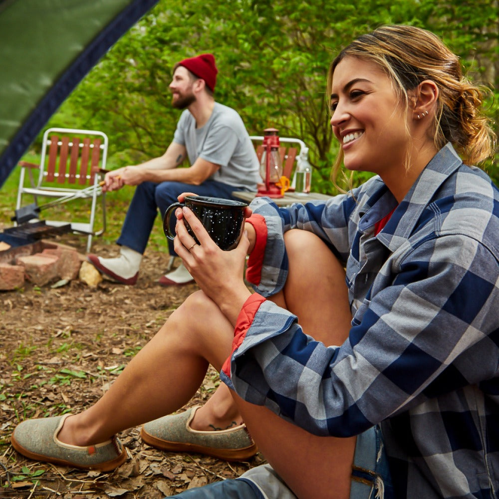 Acorn Bristol Slipper on Female Model sitting at a Campsite with Friends #color_buff-popcorn