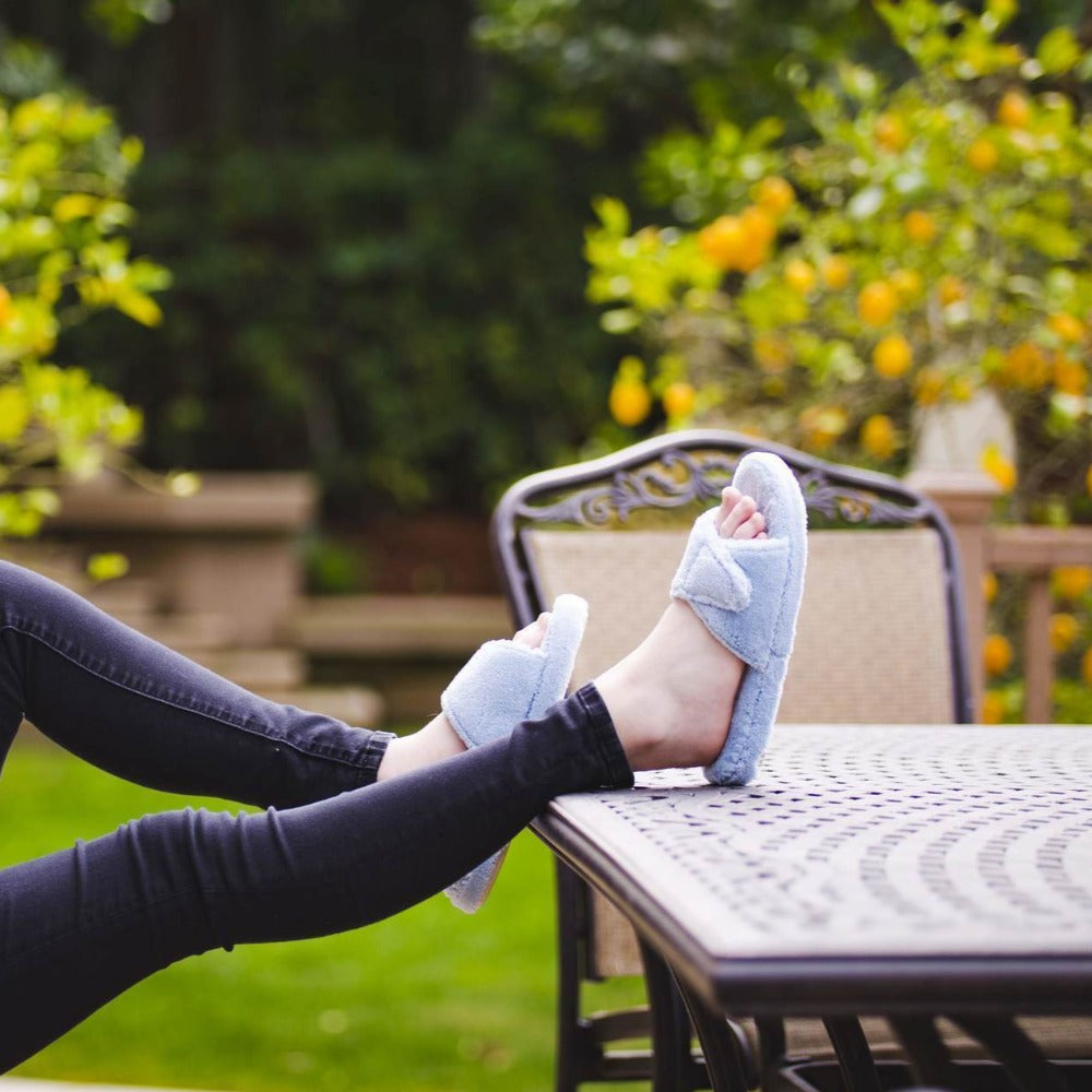 Women's Spa Slide Slippers in Powder Blue on model with feet up on outdoor patio table#color_powder-blue