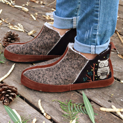 Women's Forest Bootie Slippers in Chocolate On Model with Leaves and Pine Cones#color_chocolate