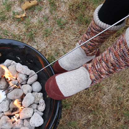 Women's Slouch Boots in Sunset Cable Knit On Model Roasting Marshmallows Over a Fire #color_sunset-cable-knit